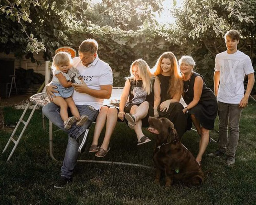 Image of Volodymyr Zhukov (right) with his family at home in Kyiv, Ukraine.