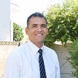 Outdoor smiling headshot of José Moreno
