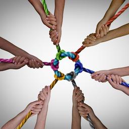 Diverse employees team meeting as a business concept for pulling together for work teamwork success and diversity symbol as a unified group working in unity.