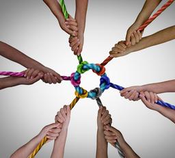 Diverse employees team meeting as a business concept for pulling together for work teamwork success and diversity symbol as a unified group working in unity.